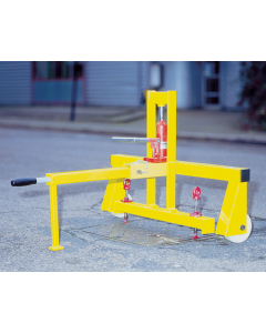 Heavy-duty Cover Lifter Hydraulic. Square tube metal frame in Yellow. Two treaded lifting keys offered up to drain cover in street.
